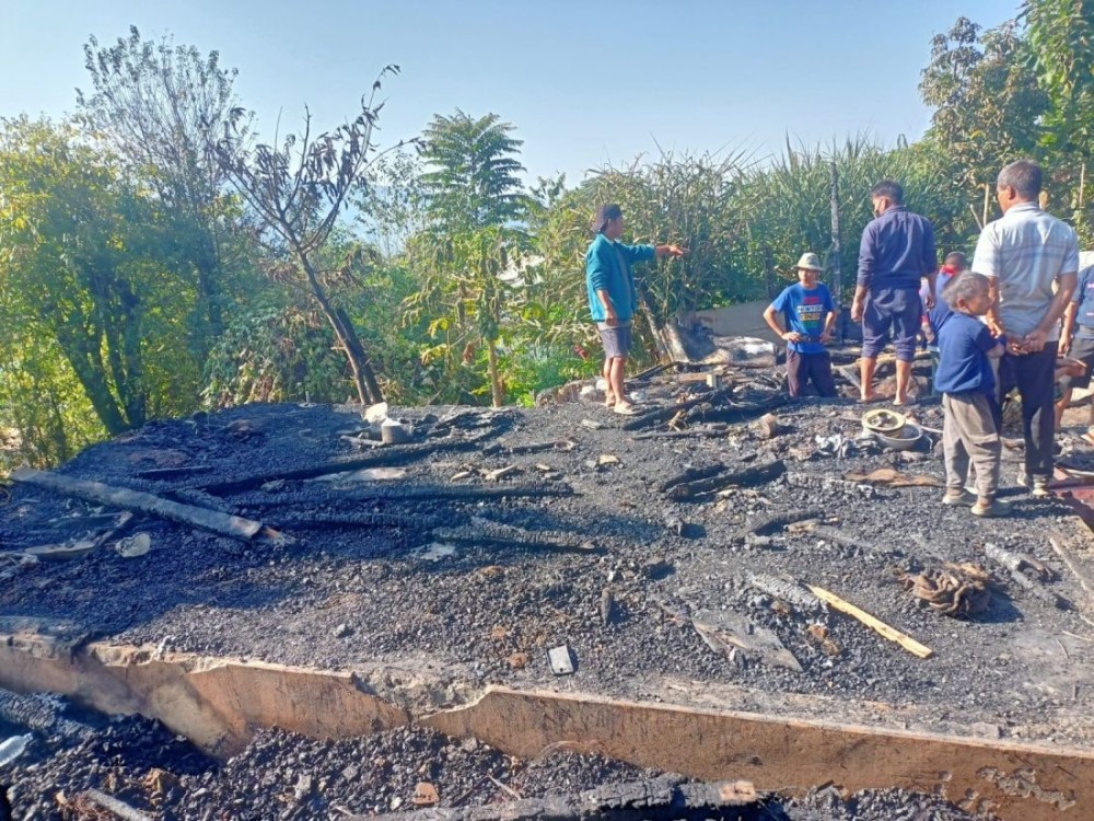 People assess the site of a house gutted in a fire at Danlepdong Colony, Noklak, on October 18. (Morung Photo)